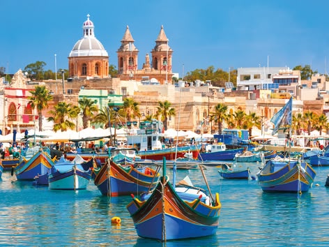 Traditional Maltese boats in Marsaxlokk fishing village.