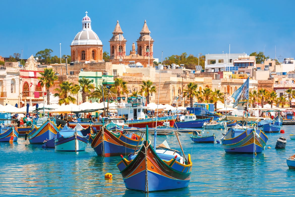 Traditional Maltese boats in Marsaxlokk fishing village.