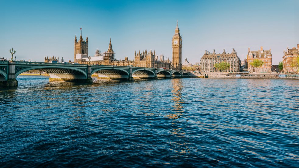 View of the River Thames with Westminster Bridge and the Houses of Parliament in London, UK.