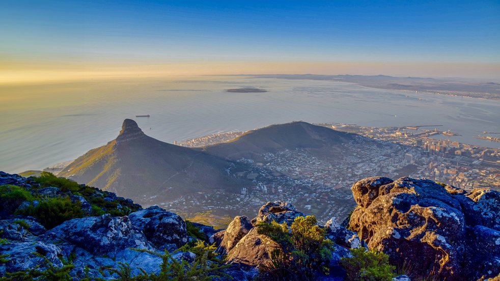 Aerial view of Cape Town, South Africa, with Lion’s Head and Table Mountain at sunset.