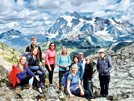 Group of hikers posing in the mountains during an outdoor excursion.